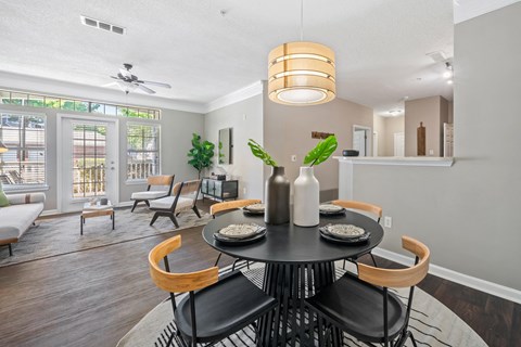 Dining room overlooking living room area  at Sugarloaf Crossings Apartments in Lawrenceville, GA 30046